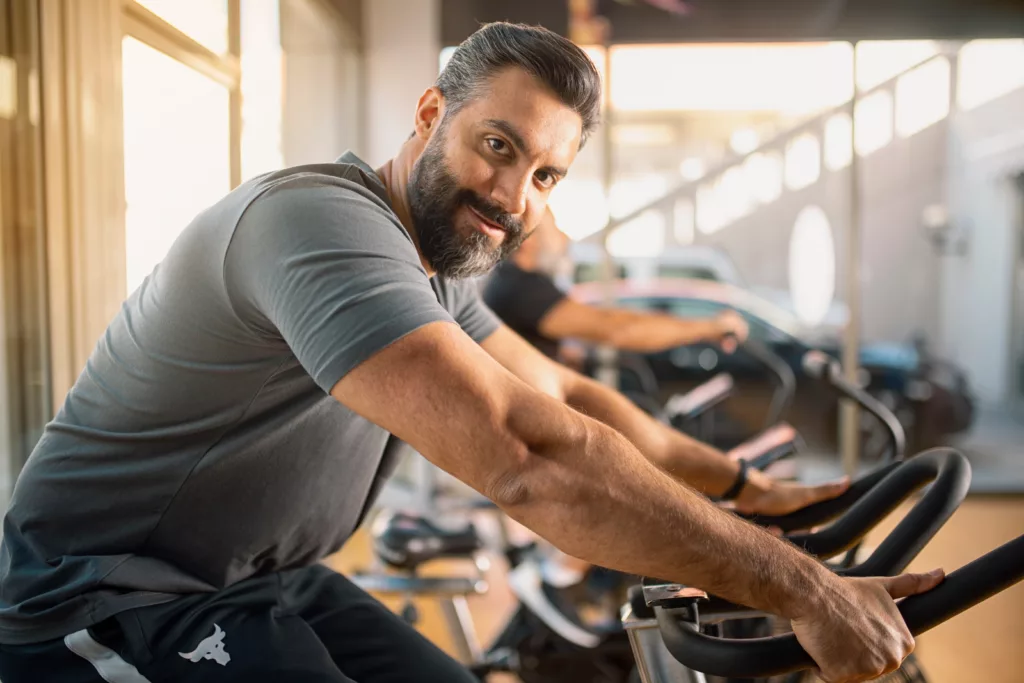 Portrait of a young, athletic man in sportswear cycling